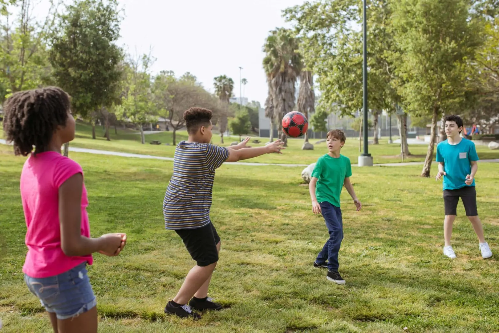 A group of people playing frisbee in the park.