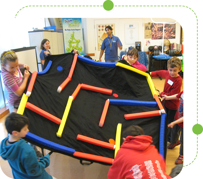 A group of kids playing with an inflatable maze.