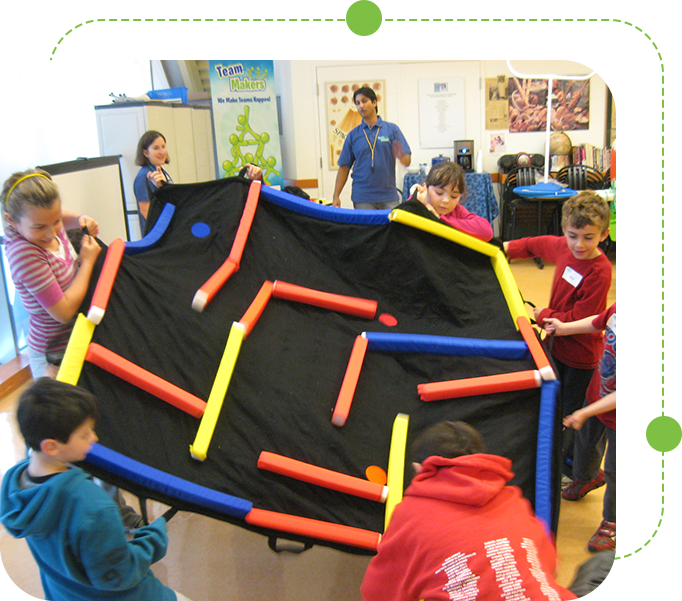 A group of kids playing with an inflatable maze.