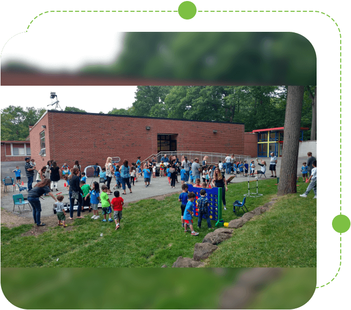 A group of people gathered outside in the grass.