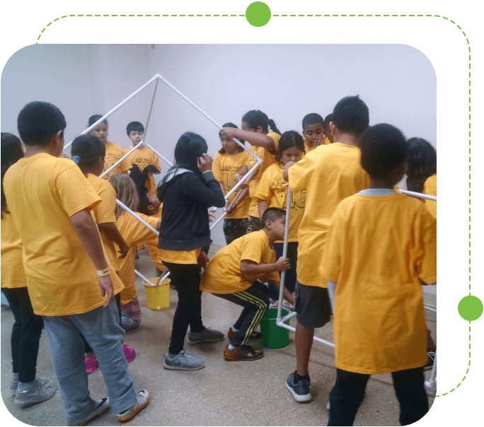 A group of kids in yellow shirts and black shorts.
