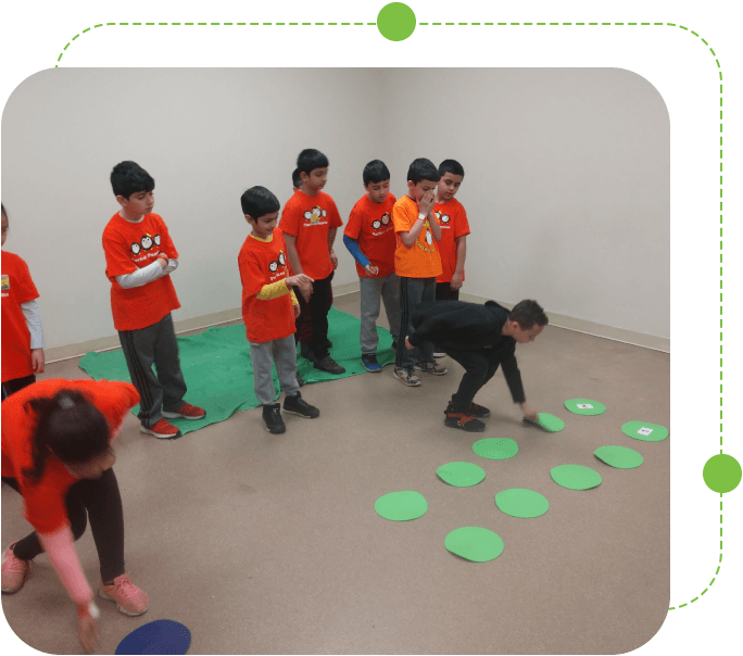 A group of kids standing around in a room.